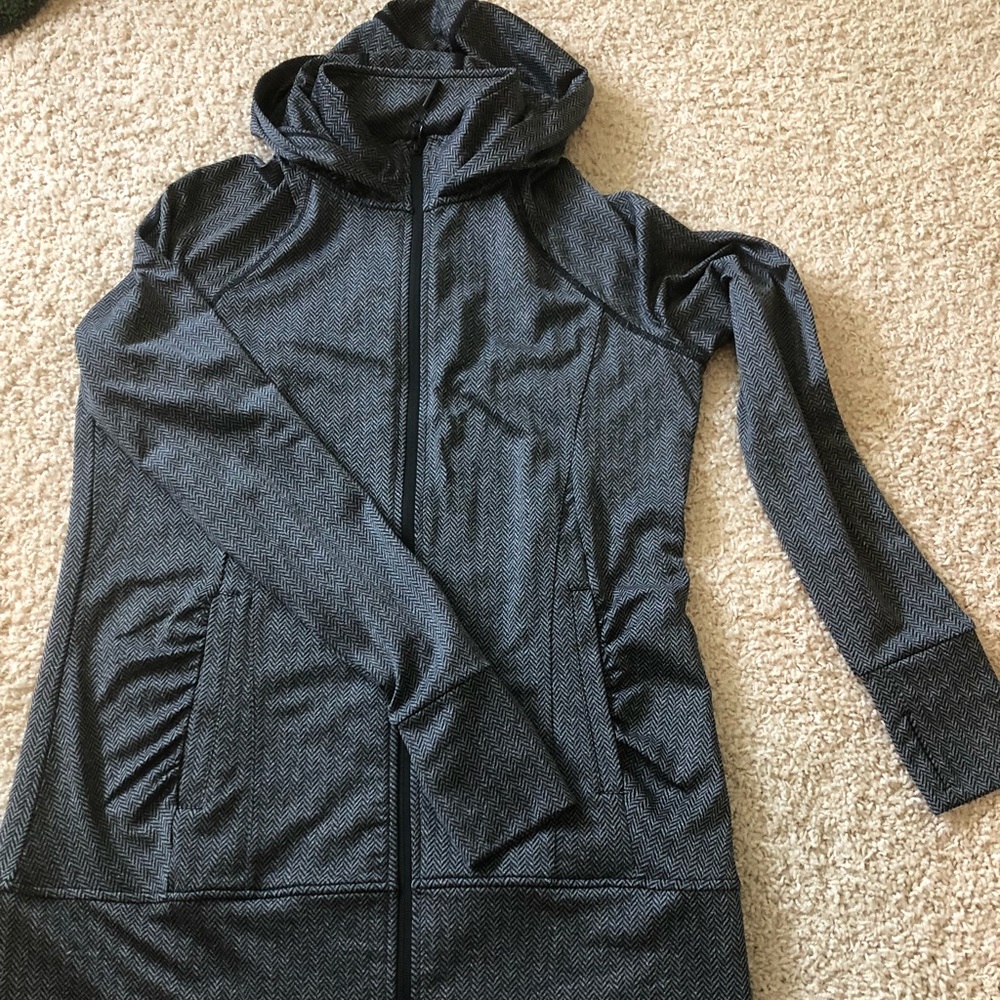 Track jacket. Zip up with hoody. Thumb holes.
